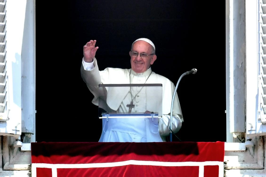 Pope Francis waves to the crowd from the window of the Apostolic Palace overlooking St Peter's square during the Sunday Angelus prayer, on July 22, 2018 at the Vatican. (AFP/Andreas Solaro)
