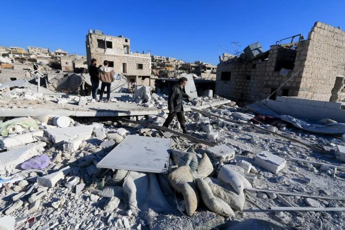 People inspect a site hit by what residents said were airstrikes carried out by the Russian air force in Idlib Governorate near the Syrian-Turkish border, January 25, 2016. (Reuters)