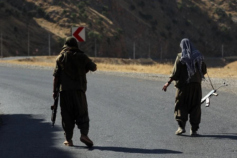 A member of the Kurdistan Workers' Party (PKK) carries an automatic rifle on a road in the Qandil Mountains, the PKK headquarters in northern Iraq. (File Photo: AFP)