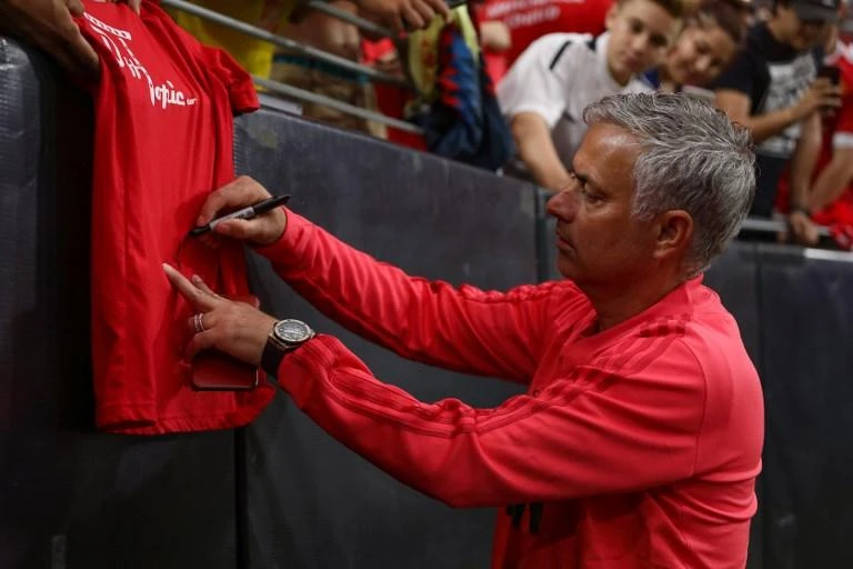 Manchester United manager Jose Mourinho signs an autograph prior to the International Champions Cup game against Club America at the University of Phoenix Stadium on July 19, 2018. (AFP)