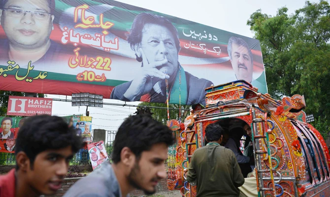 An election billboard featuring an image of Pakistani cricketer turned politician Imran Khan (top C) of the Pakistan Tehreek-e-Insaf is pictured over a street ahead of the general election in Rawalpindi on July 23, 2018. (AFP)