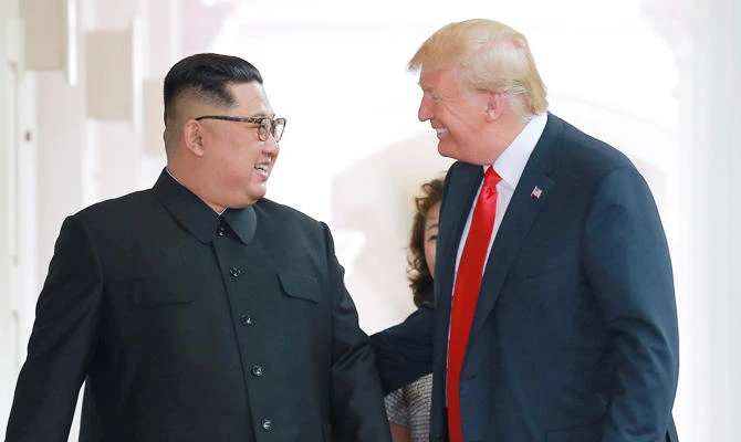 US President Donald Trump walks with North Korean leader Kim Jong Un at the Capella Hotel on Sentosa island in Singapore in this photo taken on June 12, 2018. (REUTERS)