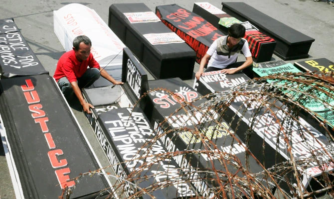 In this Monday, Sept. 21, 2015 photo, protesters display several mock coffins representing victims of killings of activists and Indigenous Peoples to commemorate the 43rd declaration of Martial Law in the country by the late Philippine strongman Ferdinand Marcos. (AP)