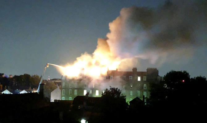 Firefighters tackle a blaze in a block of flats on fire in West Hampstead, London, England, on Wednesday, July 26, 2018. (REUTERS)