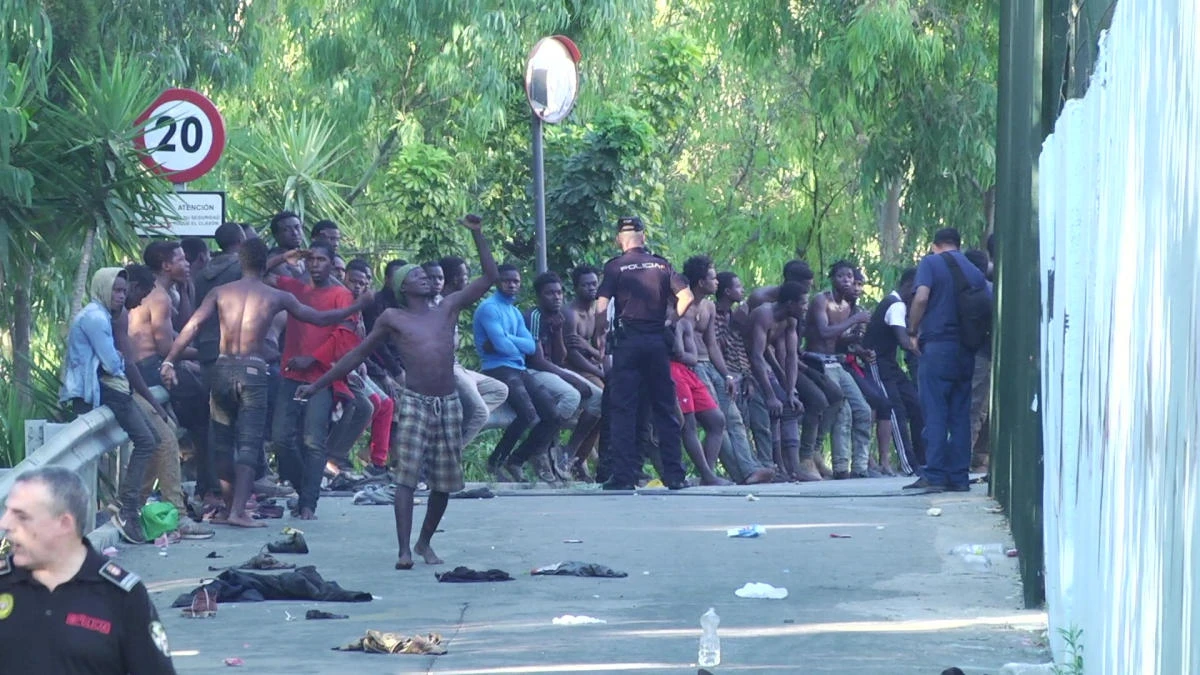 African migrants gather after crossing the border from Morocco to Spain’s North African enclave of Ceuta. (Reuters)