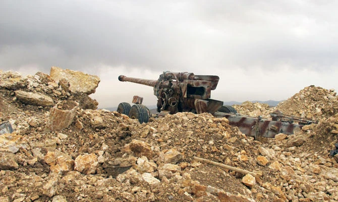 This May 9, 2015 photo shows a Hezbollah cannon directed toward Syria in a military position for the group in the fields of the Lebanese border village of Brital, Lebanon. (AP)