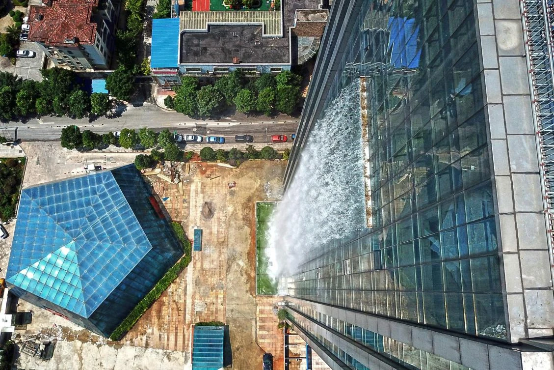 An aerial view of a 108-meter-high (350 feet) artificial waterfall on the facade of the Liebian International Building in Guiyang in China's Guizhou province. (Reuters)