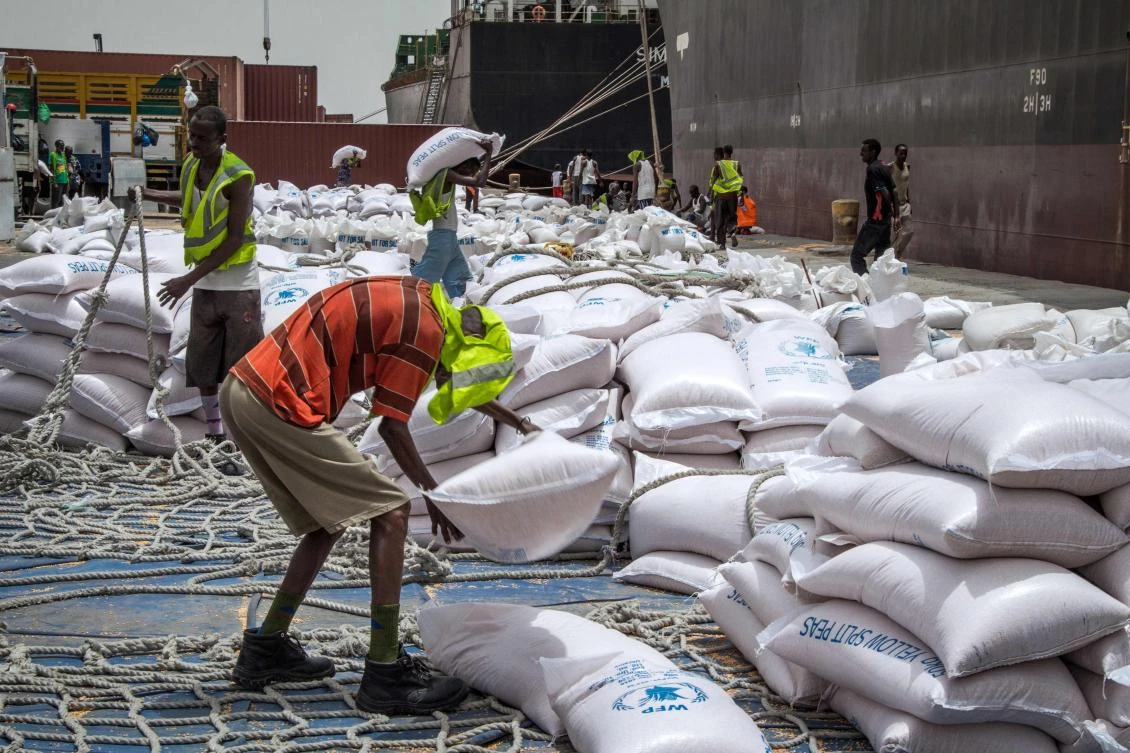 A worker drops food rations from a ship before loading trucks at Berbera port of Somaliland. (AFP)