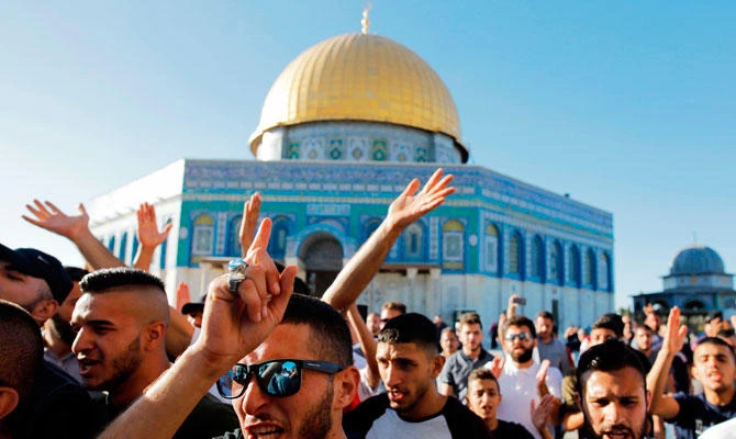 Palestinians shout slogans in front of the Dome of the Rock at the al-Aqsa mosque compound in the Jerusalem's Old City on July 27, 2018, after the site was reopened. (AFP)