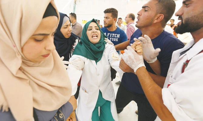 A Palestinian nurse mourns her husband who was killed by Israeli troops during a protest in the southern Gaza Strip on Friday. (Reuters)
