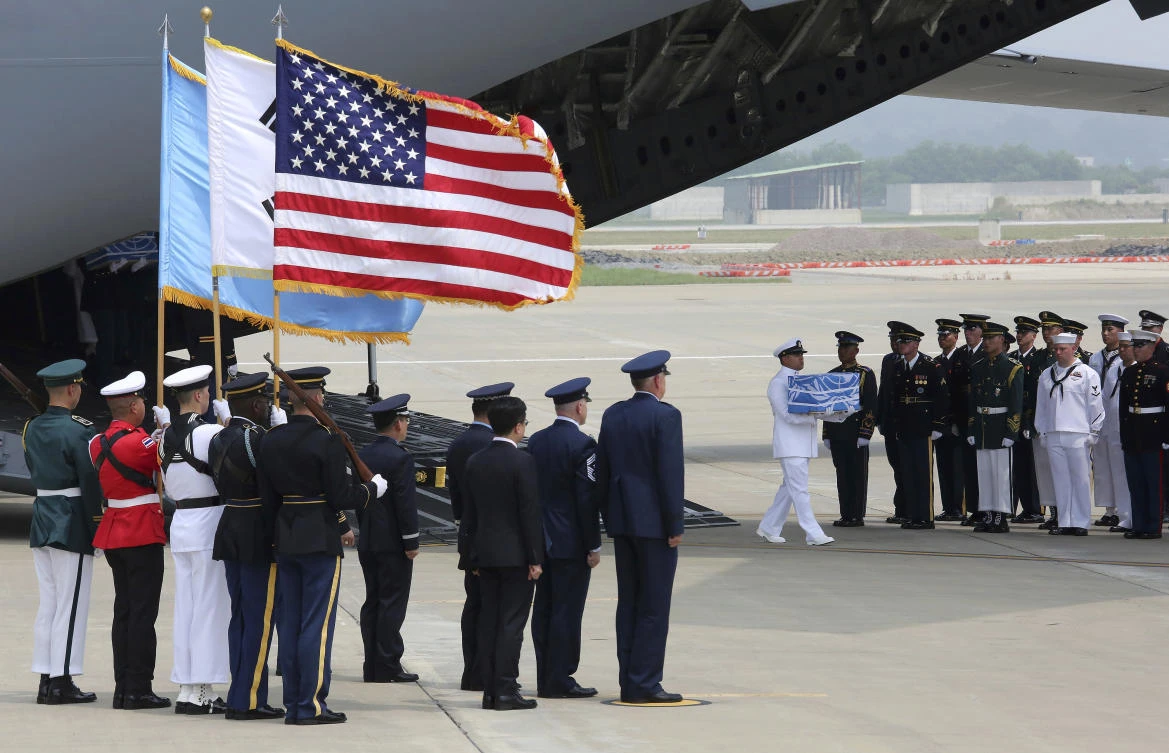 A UN honor guard carries a box containing remains believed to be from American servicemen killed during the 1950-53 Korean War after arriving from North Korea, at Osan Air Base in Pyeongtaek, South Korea. (AP Photo/Ahn Young-joon. Pool)