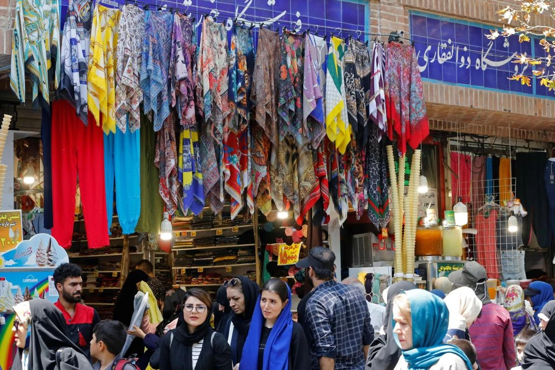 Iranians walk inside Tehran’s ancient Grand Bazaar in Tehran on July 28, 2018. (AFP)