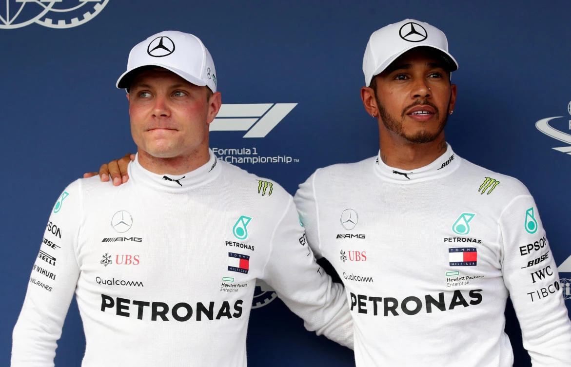 Mercedes' Lewis Hamilton (R) celebrates after qualifying in pole position with second placed Mercedes' Valtteri Bottas (L). (REUTERS/Lisi Niesner)