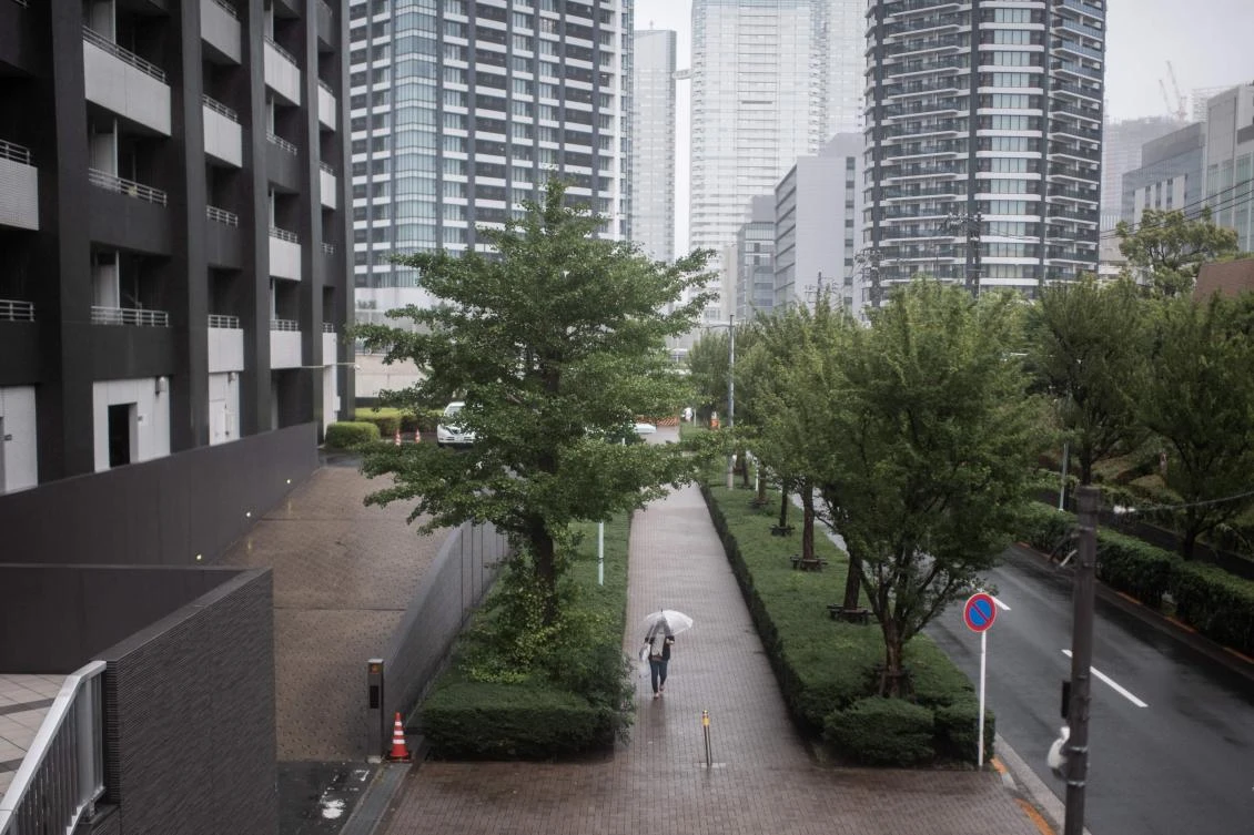 A woman protects herself from the rain with an umbrella in Tokyo on July 28, 2018, as the country braces for Typhoon Jongdari. (AFP)