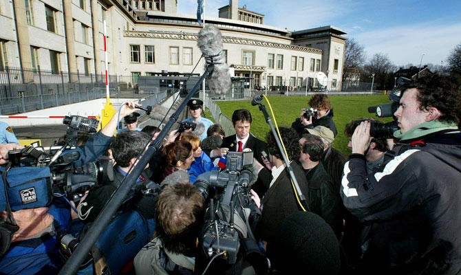 Dragoslav Ognjanovic, adviser to Slobodan Milosevic, is surrounded by media during a break on the second day of the trial against Milosevic at the International Criminal Tribunal for the former Yugoslavia at The Hague, in this February 13, 2002 file photo. (REUTERS)