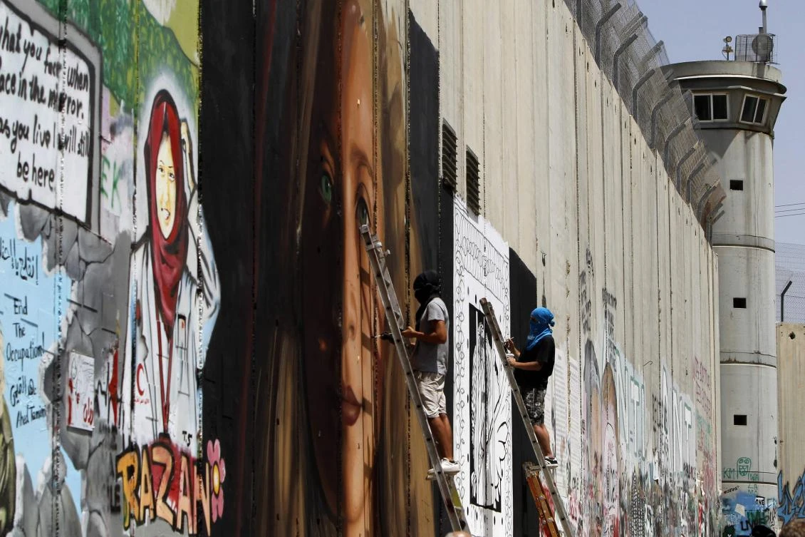 Italians who painted portrait of Palestinian teen on Israel’s separation wall arrested