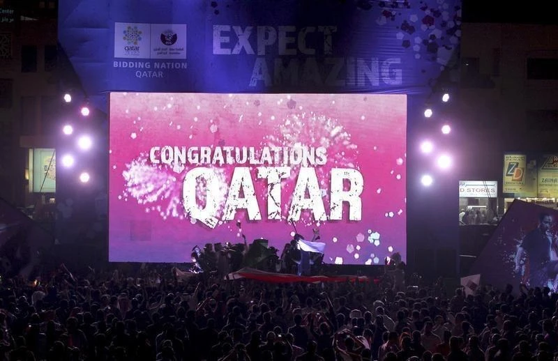 People celebrate in front of a screen that reads "Congratulations Qatar" after FIFA announced that Qatar would host the 2022 World Cup. (Reuters)