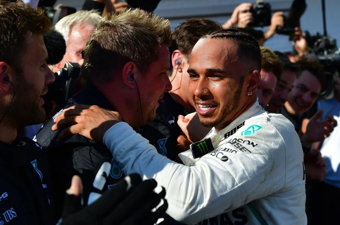 Mercedes' British driver Lewis Hamilton is congratulated by team members after winning the Formula One Hungarian Grand Prix at the Hungaroring circuit on July 29, 2018. (AFP/Andrej ISAKOVIC)