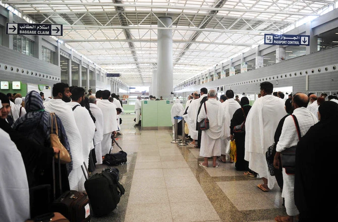 Muslim pilgrims wait to pass security as the first pilgrims for the annual Hajj pilgrimage arrive in Jeddah. (File photo / AFP)