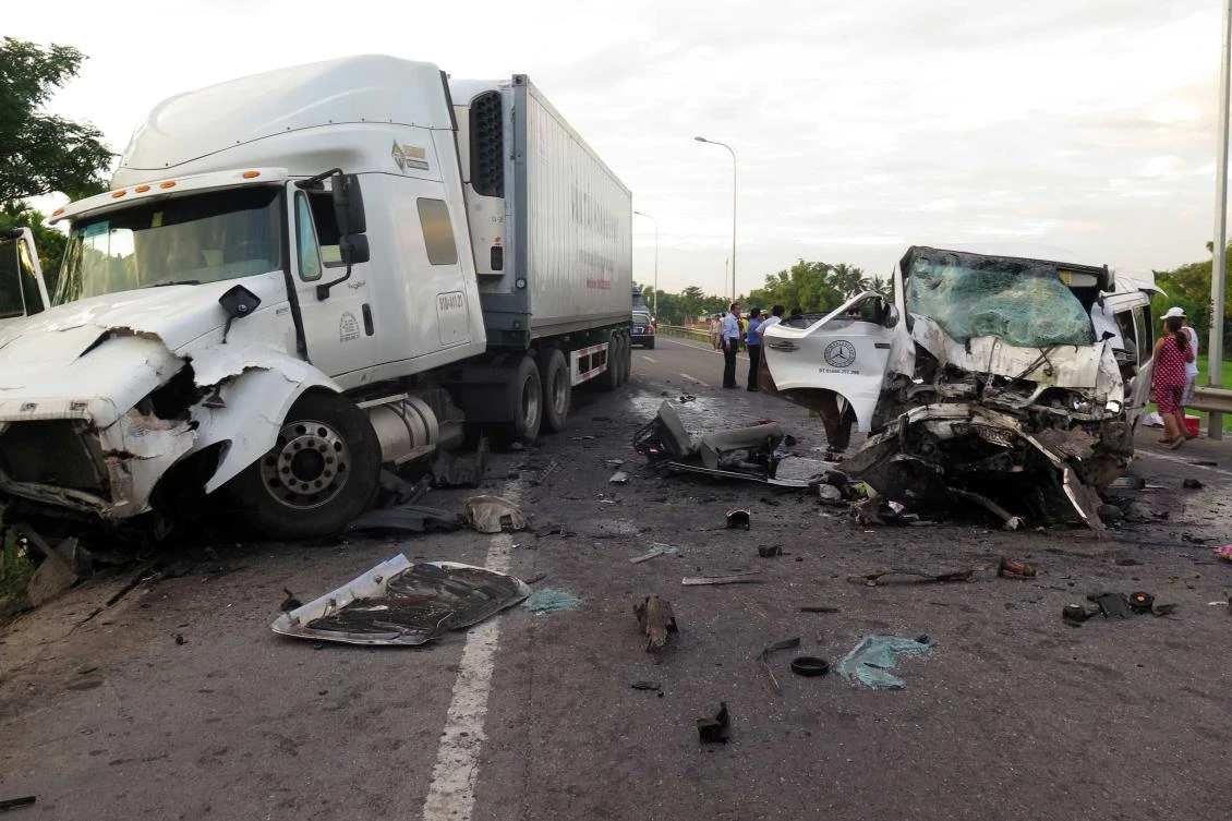 Debris is strewn after a van headed to a wedding party hit a container truck early Monday morning along a road in Quang Nam province of Vietnam. (Vietnam News Agency/AFP)