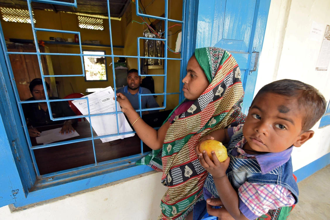 An Indian woman checks her name on the draft list of the National Register of Citizens in Chandamari village in Goalpara district in the northeastern state of Assam. (Reuters)