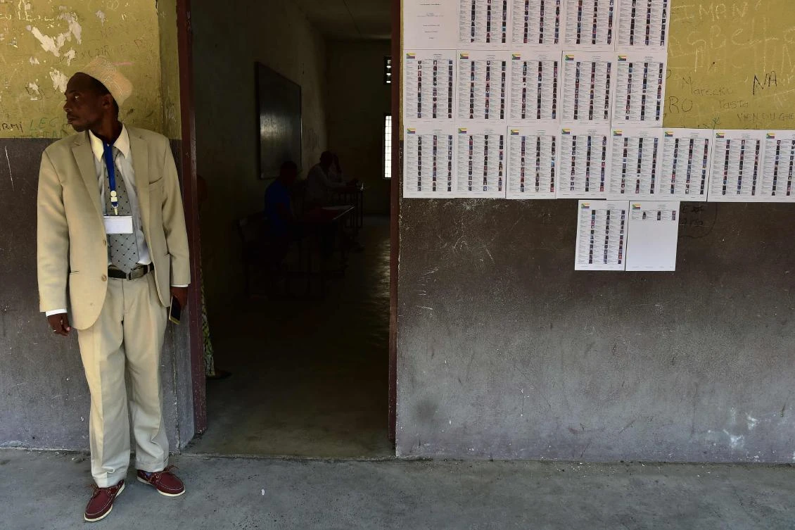 A polling station official stands by the entrance of one of the classrooms being used as a polling station on July 30, 2018 on the day of a constitutional referendum in Moroni, capital of the Comoros Archipelago during a politically explosive referendum that could change the constitution and allow President Azali Assoumani to rule beyond 2021, his current term limit. (AFP)