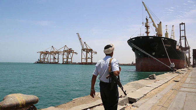 Houthi militant walks near a ship in Hodeidah. (Reuters)