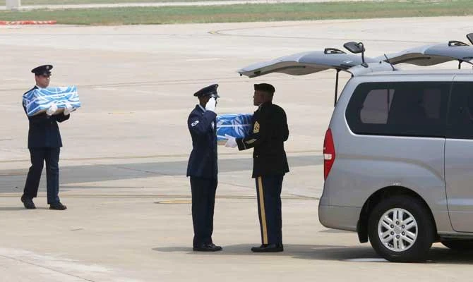 A UN honor guard salutes after turning over a box containing remains believed to be from American servicemen killed during the 1950-53 Korean War, to his fellow after arriving from North Korea, at Osan Air Base in Pyeongtaek, South Korea, in this July 27, 2018 photo. (AP)