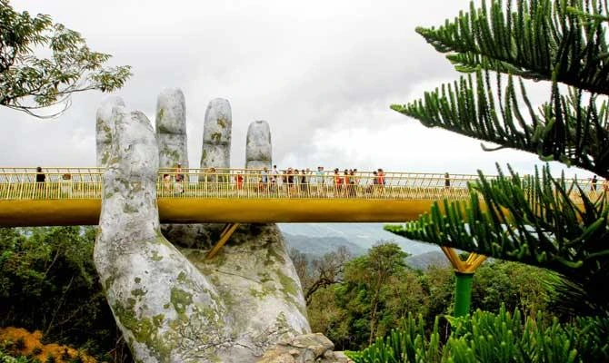 In this photo taken on July 31, 2018, visitors walk along the 150-meter long Cau Vang "Golden Bridge" in the Ba Na Hills near Danang. (AFP)