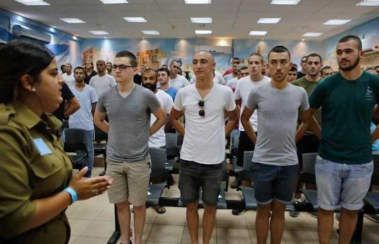 An Israeli soldier guides a group of conscripts at the Tel Hashomer Army Recruitment Center near Tel Aviv on Sunday, July 26. (AFP)