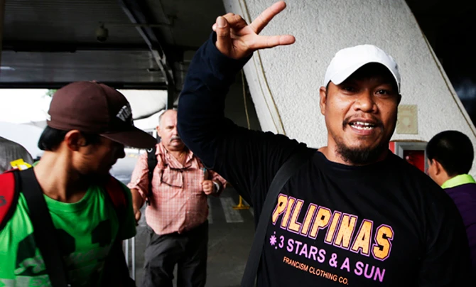 In this August 2014 file photo, Filipino workers repatriated from Libya arrive in Manila amid fighting in the Mideastern nation. On Friday, three Filipino workers were seized in Libya by a still unidentified group. (AP file photo)