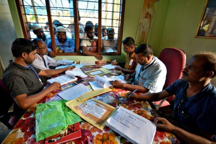 People wait to check their names on the draft list at the National Register of Citizens (NRC) center at a village in Nagaon district, Assam state. Four million people were not included in the draft list which was published Monday. (Reuters)