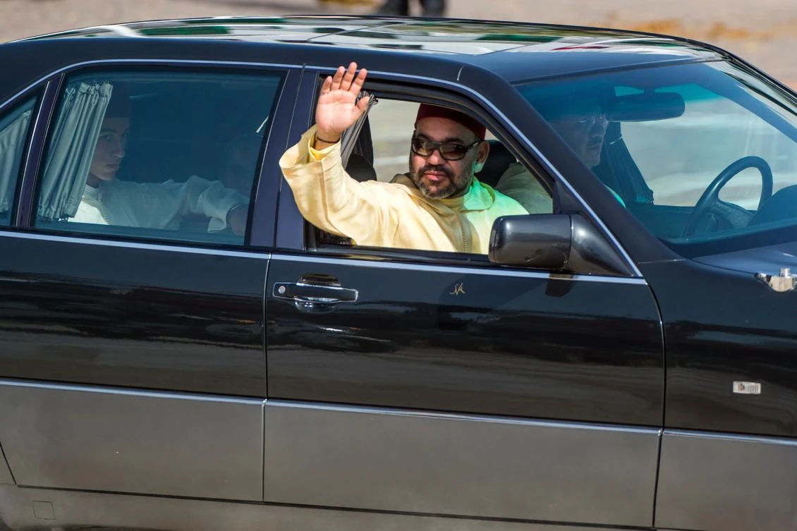 Moroccan king Mohammed VI (front seat) and the crown prince of Morocco, Moulay Hassan (back seat) leave a ceremony of allegiance, at the King's palace in Tetouan, on July 31, 2018, to mark the 19th anniversary of Mohammed VI's accession to the throne. (AFP)