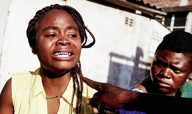 A girl cries after being allegedly beaten as soldiers disperse demonstrators on August 1 2018, in Harare, as protests erupted over alleged fraud in the country's election. (AFP)