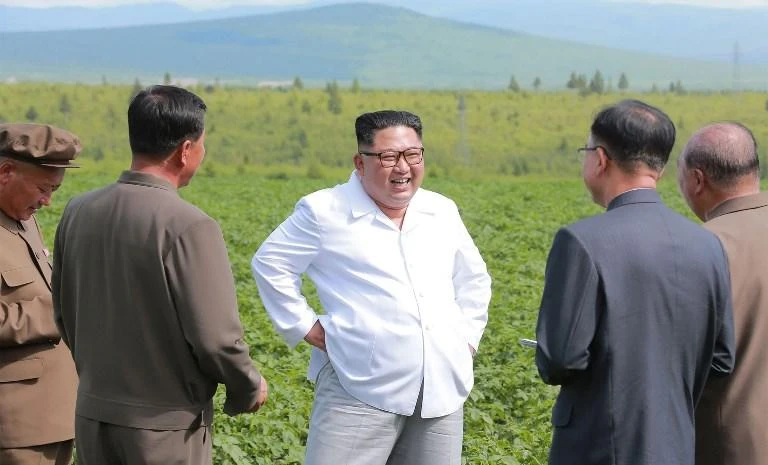 An undated picture released by North Korea’s official Korean Central News Agency on July 10 shows North Korean leader Kim Jong Un, Center, inspecting a farm in Samjiyon County. (KCNA via KNS/AFP)