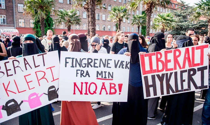Women wearing niqab to veil their faces take part in a demonstration on August 1, 2018, the first day of the implementation of the Danish face veil ban, in Copenhagen, Denmark. (AFP)