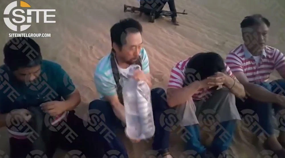 This screen grab image taken from video released on August 1, 2018 and provided courtesy of the SITE Intelligence Group shows four hostages, who are foreign employees of an engineering company in Tripoli, Libya. (AFP)