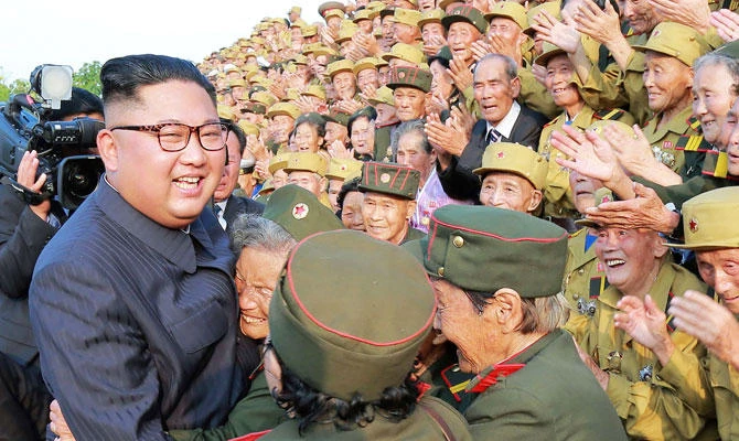 This undated photo released from North Korea's official Korean Central News Agency (KCNA) on July 27, 2018 shows North Korean leader Kim Jong Un (L) meeting with participants of the 5th National Conference of War Veterans in front of the Fatherland Liberation War Martyrs Cemetery in Pyongyang. (AFP)