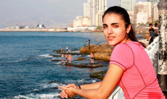 Nour Safieddine, 24, warms up ahead of running along the seafront in the Lebanese capital Beirut on July 13, 2018. (AFP)
