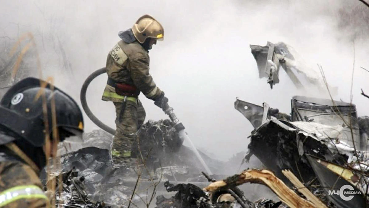 In this image made from a Russian Emergency Situations Ministry video, a firefighter works to extinguish a fire at crash side of a Russian helicopter Mi-8 crashed shortly after takeoff in Vankor, above the Arctic Circle in Siberia, Russia, Saturday, Aug. 4, 2018. (AP)