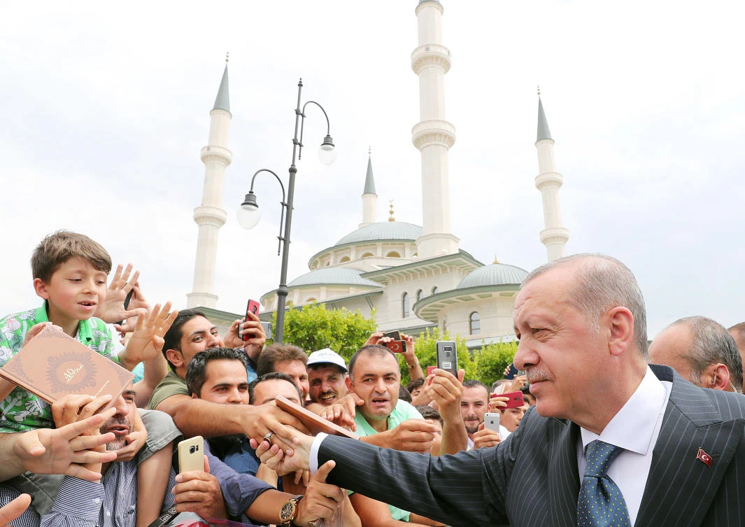 Turkish President Tayyip Erdogan greets his supporters as he leaves from a mosque following the Friday prayers in Ankara, Turkey, on Friday, August 3, 2018. (REUTERS)