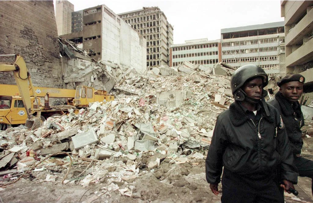 Kenyan security guards keep watch over the scene of the bomb explosion the day before near the US embassy in Nairobi on August 8, 1998. (AFP/Alexander Joe)