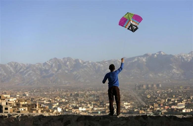 A boy flies a kite over Kabul, where the underserved health care sector is attracting investment from the Gulf. (Reuters)