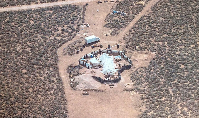 This Aug. 3, 2018, aerial photo released by Taos County Sheriff's Office shows a rural compound during an unsuccessful search for a missing 3-year-old boy in Amalia, N.M. (AP)