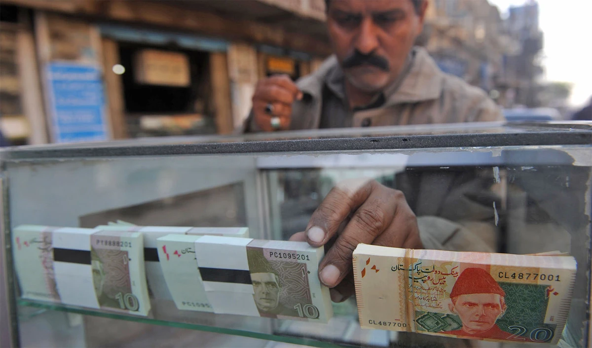 In this file photo, a vendor arranges Pakistani bank notes in a display shelf at a commercial area in Karachi on Dec. 14, 2011. (RIZWAN TABASSUM/AFP)