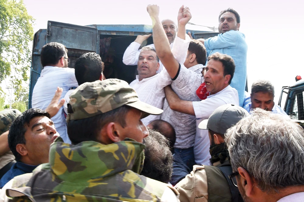 Traders shout slogans from a police vehicle after being detained during Monday's march in Srinagar. (AFP)