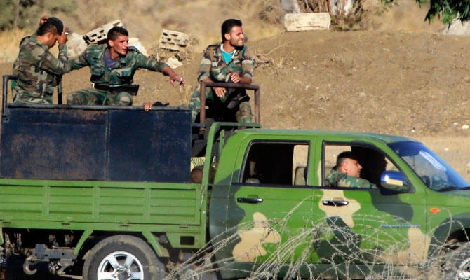 In this July 26, 2018 file photo, Syrian soldiers arrive to Syria's Quneitra border crossing between Syria and the Israeli-controlled Golan Heights. (AP)