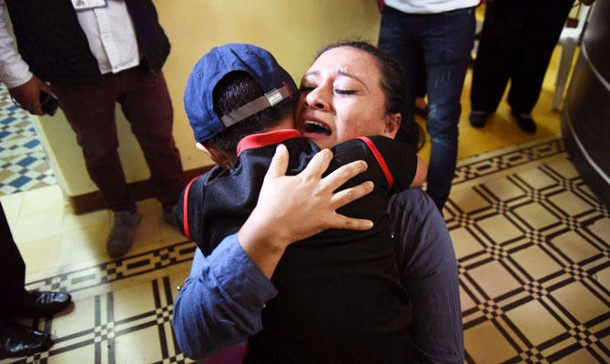 Lourdes de Leon hugs her son Leo -one of three minors who had been separated from their family on the US border- upon arrival at the shelter "Nuestras Raíces" in Guatemala City, on August 7, 2018. (AFP)