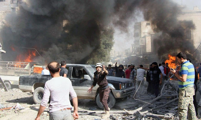 This file photo provided on Oct. 8, 2017 by the Syrian Civil Defense White Helmets, which has been authenticated based on its contents and other AP reporting, shows Civil Defense workers and Syrian citizens gathering after an airstrike hit a market in Maaret al-Numan in southern Idlib, Syria. (AP)