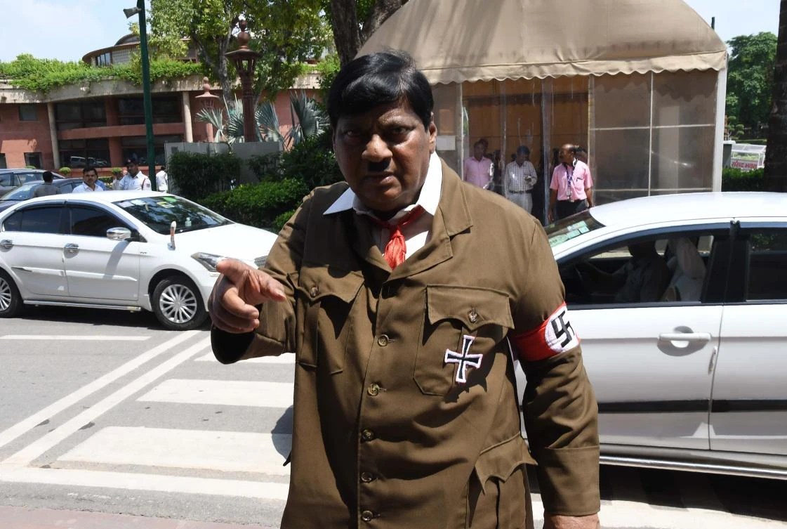 Indian film actor turned politician Naramalli Sivaprasad, arrives at parliament, in New Delhi, dressed as Adolf Hitler to press for government funding for his home state of Andhra Pradesh. (AFP)